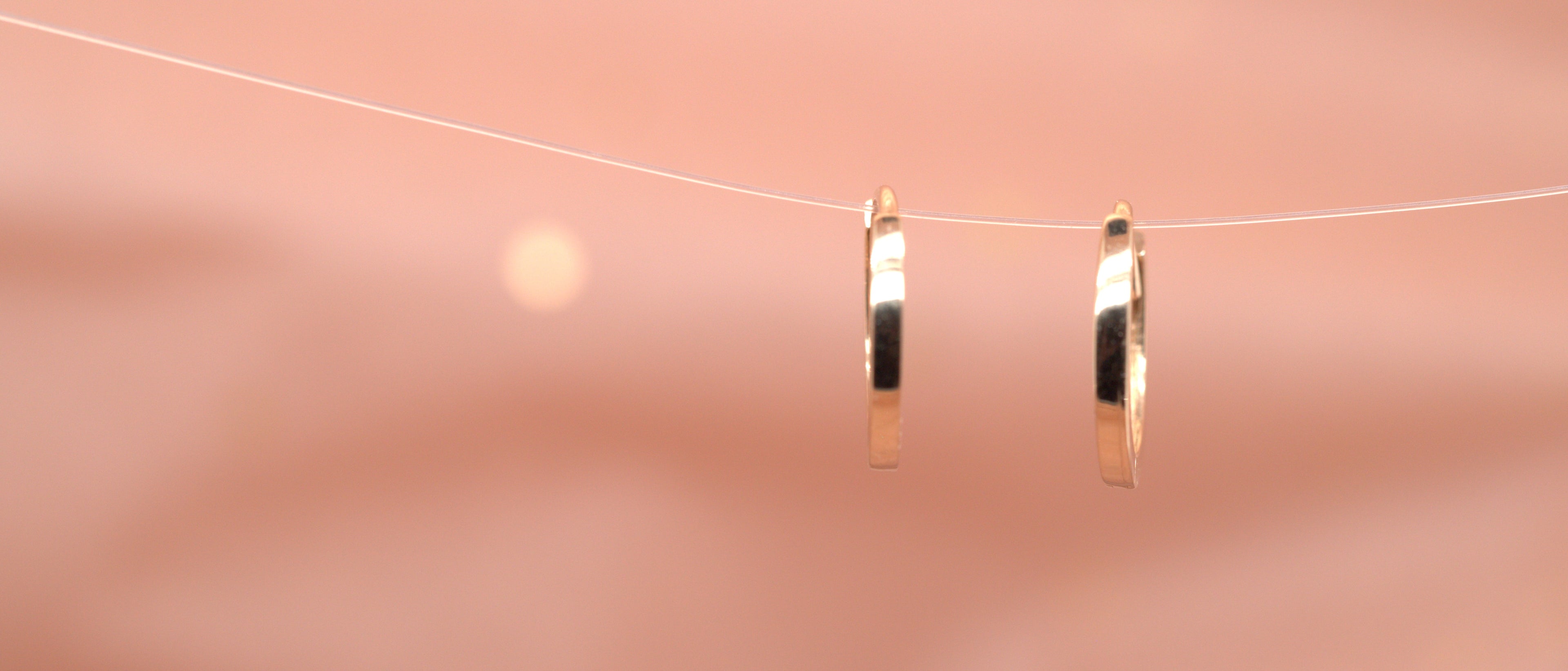 Small gold hoops suspended on a wire